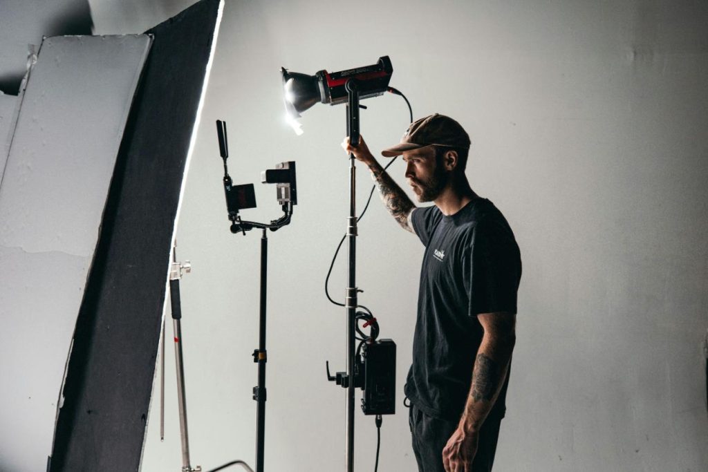 Man adjusting studio lighting